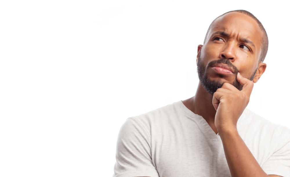a man stands with his head tilted | dental implants colorado springs
