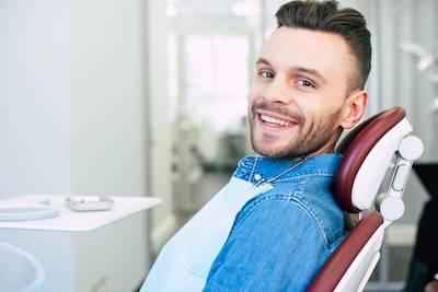 Man relaxing in dental chair after emergency treatment in Colorado Springs