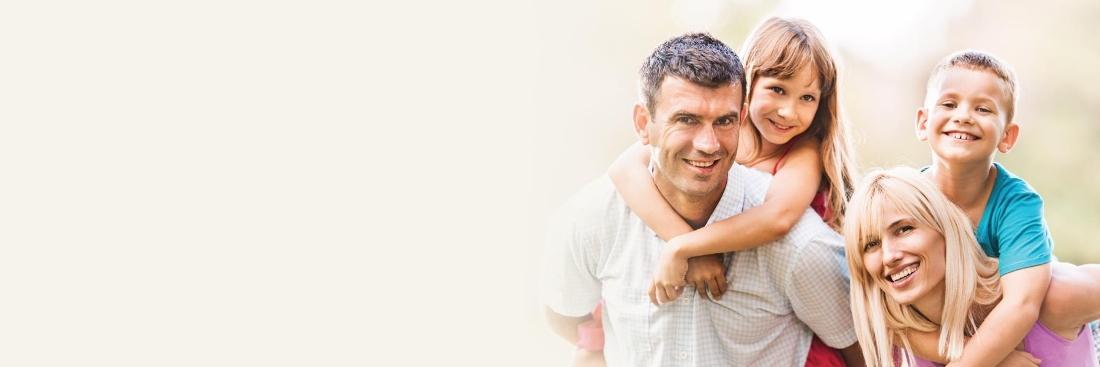 Family of four smiling after visiting Springs Family Dental