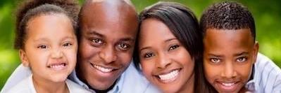 Family of four smiling after visiting Springs Family Dental