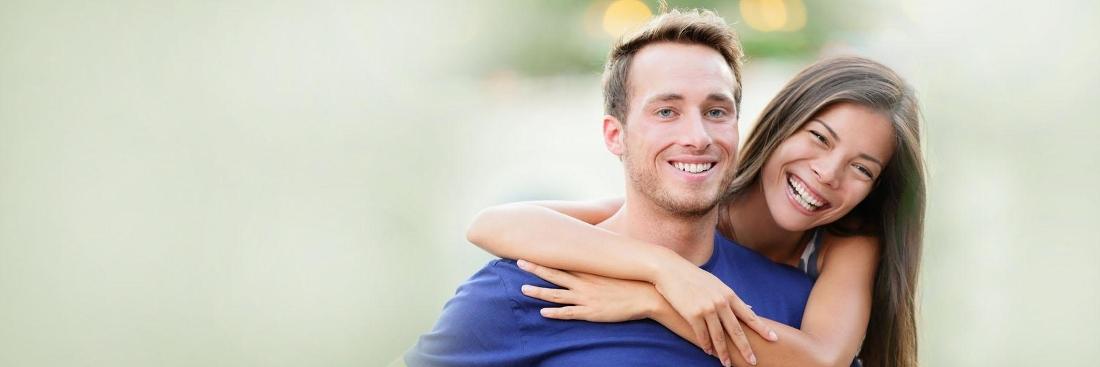 Couple hugging after getting dental crowns in Colorado Springs