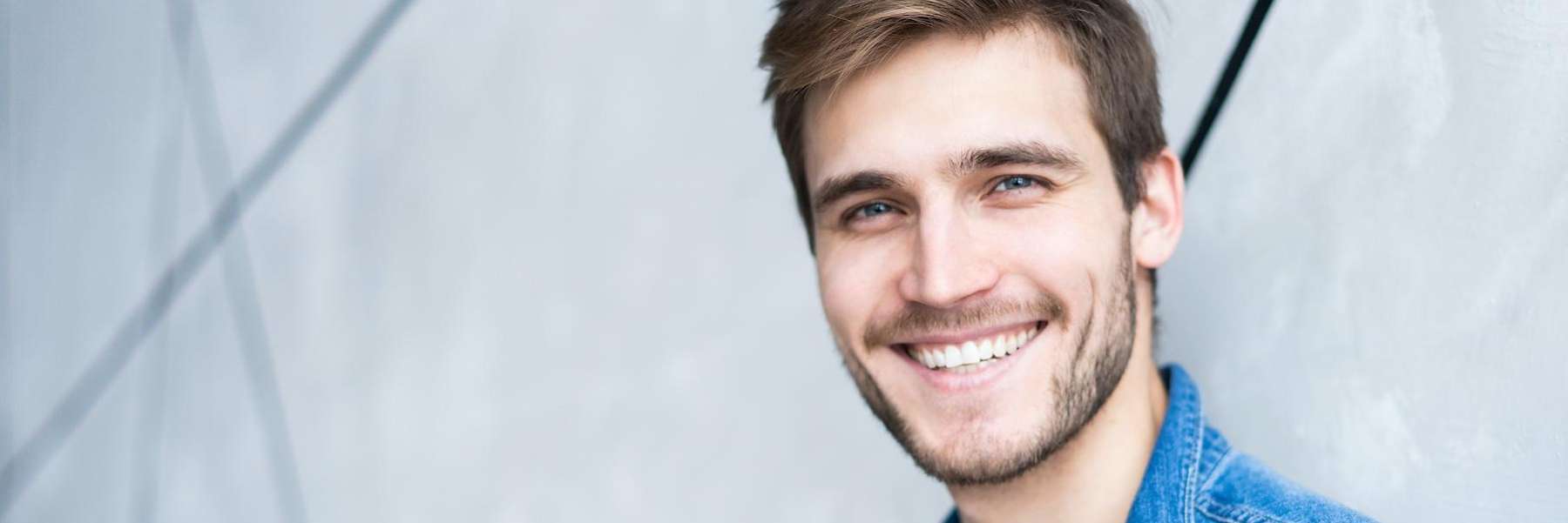 Man smiling after undergoing dental cleaning in Colorado Springs