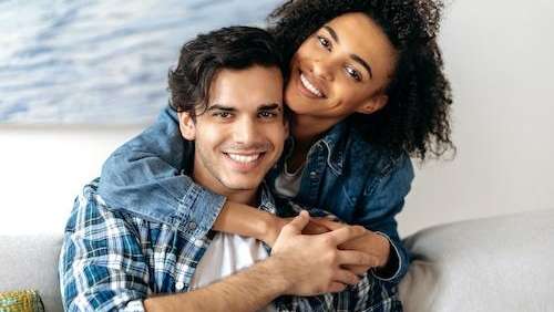 Couple smiling after teeth whitening in Colorado Springs