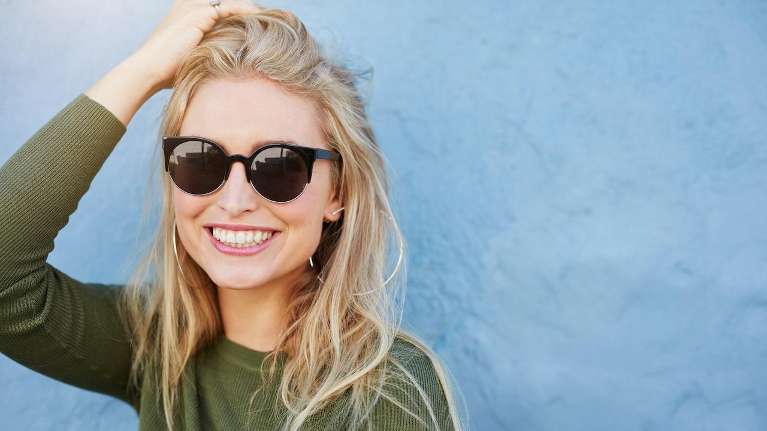 Lady with goggles smiling after teeth whitening at Springs Family Dental