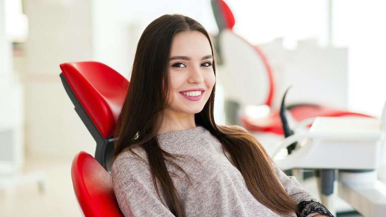 Lady smiling after getting dental crowns in Colorado Springs