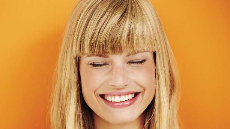 Lady shows off her teeth after teeth whitening in Colorado Springs