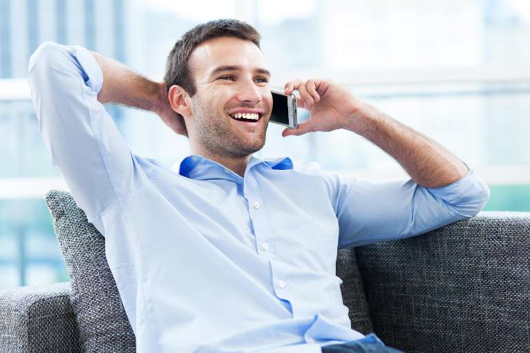 A man placing a call to Dental Implant Specialist in Colorado Springs Today